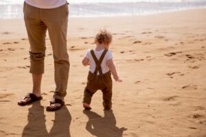 baby walking on the beach